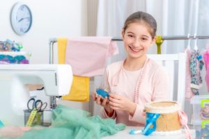 smiling girl while sewing